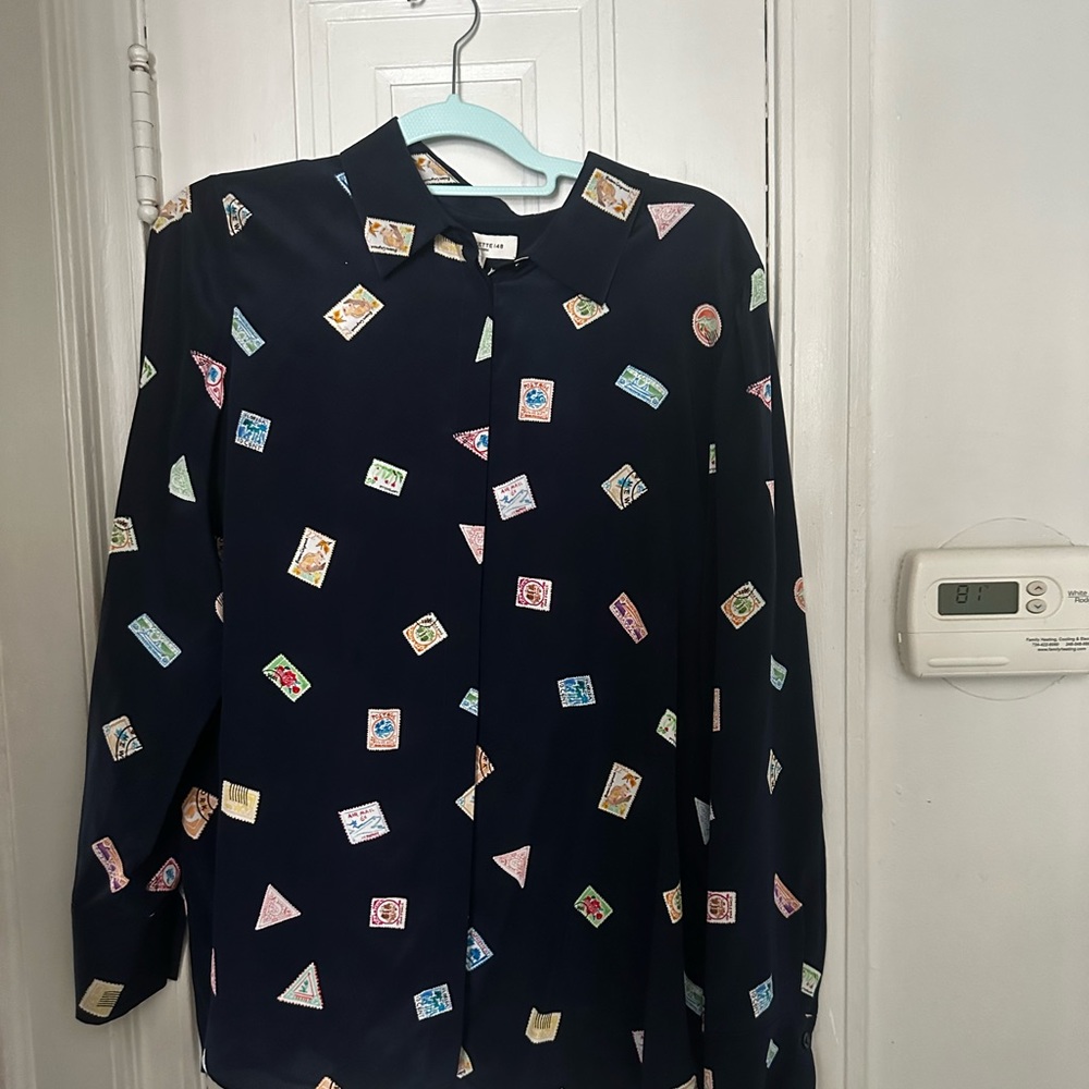 A beautiful button-down blouse navy blue with post stamps on it